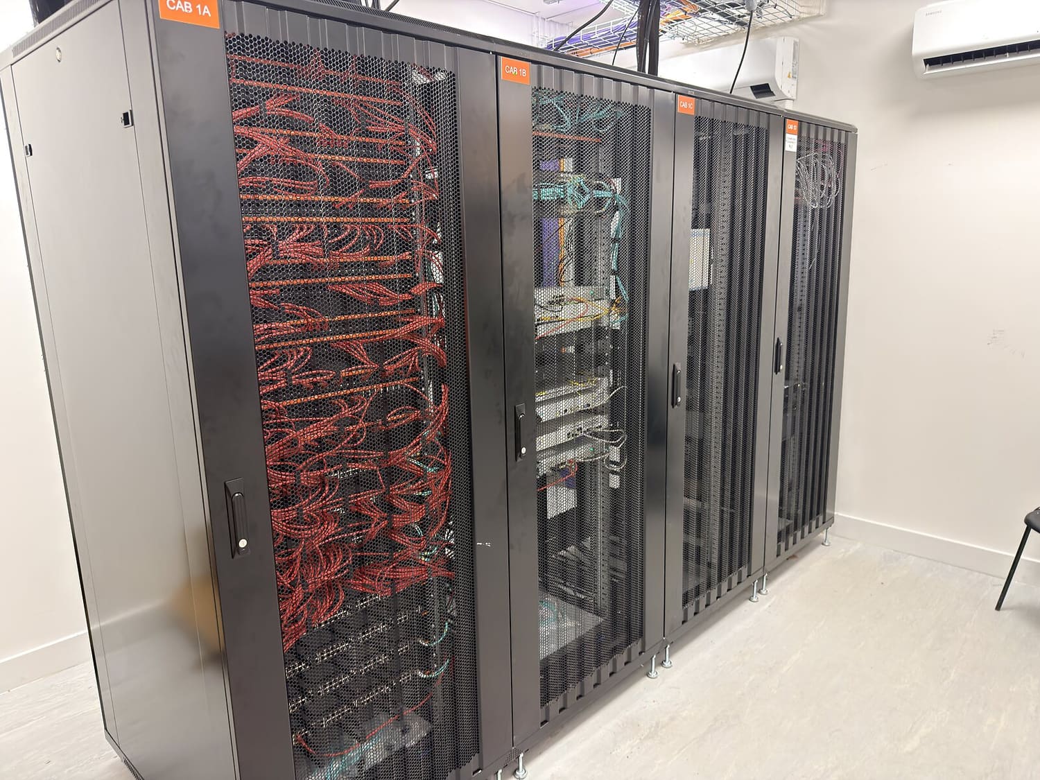 A Simplinet-delivered comms room — rows of cabinets and structured cabling